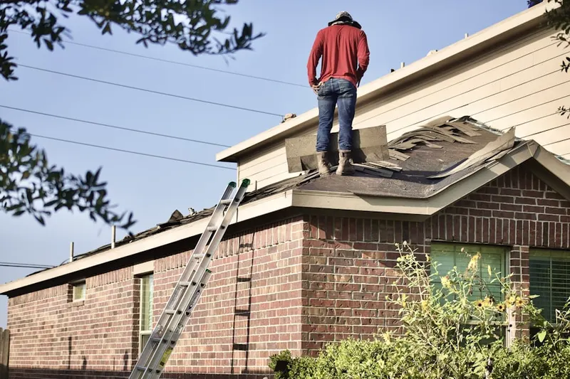 Professional roofer working on a residential roof in Chews